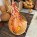 A close of up the left side of the gourd artwork. It shows an elongated oak leaf and acorns.